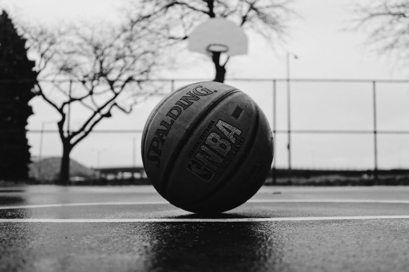 Player rising for a dunk under the lights